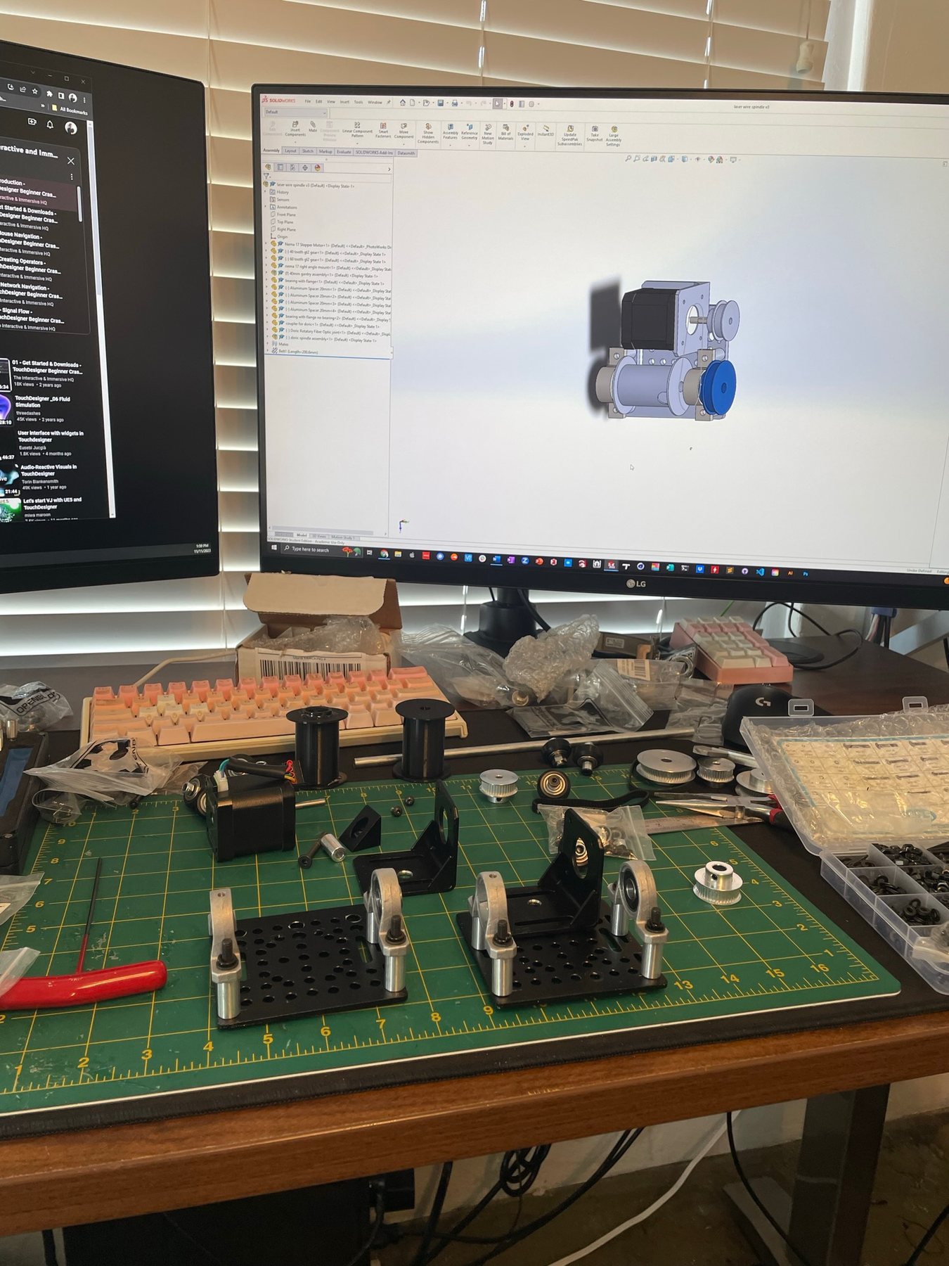 Roller and coupling parts on the bench with CAD on screen
