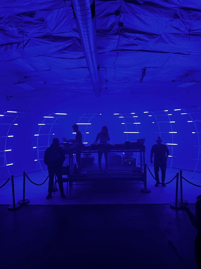Blue-lit stage with arched light structure